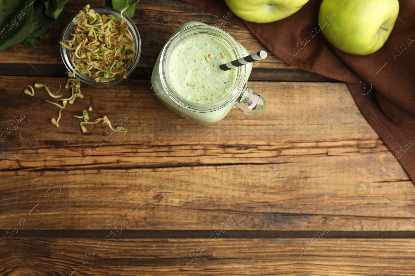 Photo of Flat lay composition with green buckwheat smoothie on wooden table, space for text