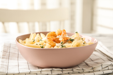 Delicious pasta with shrimps on table indoors