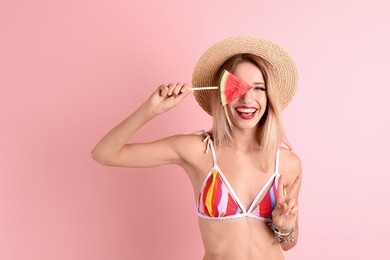 Photo of Pretty young woman with juicy watermelon on color background