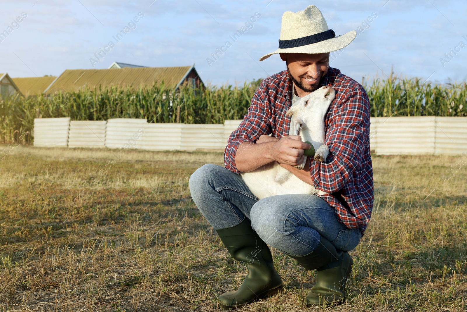 Photo of Man with goat at farm. Animal husbandry