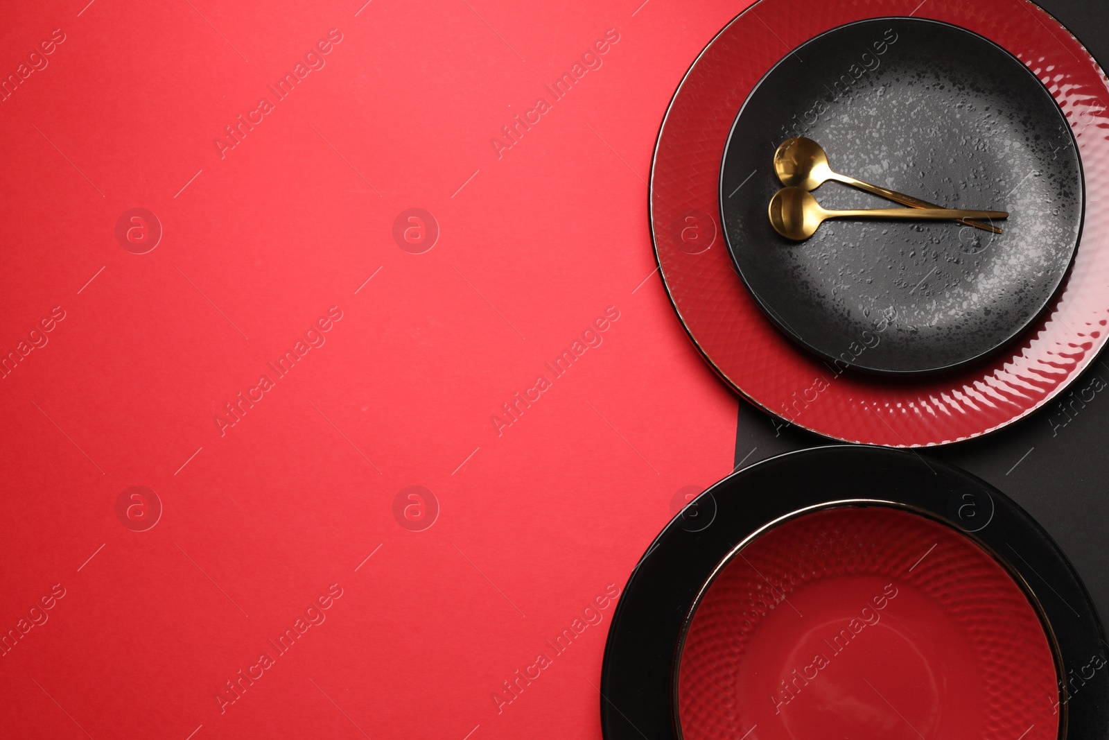 Photo of Stylish table setting with plates and spoons on color background, top view. Space for text
