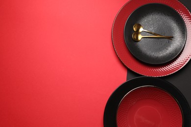 Stylish table setting with plates and spoons on color background, top view. Space for text