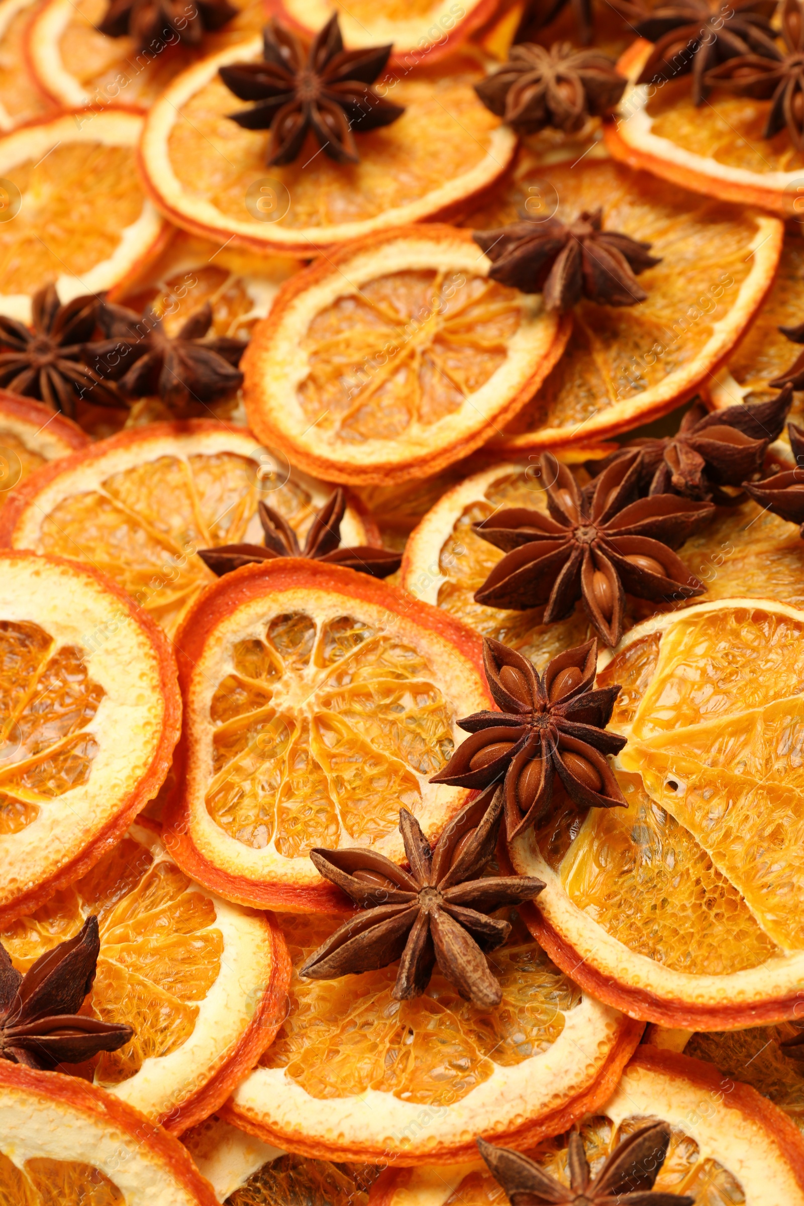 Photo of Dry orange slices and anise stars as background, closeup