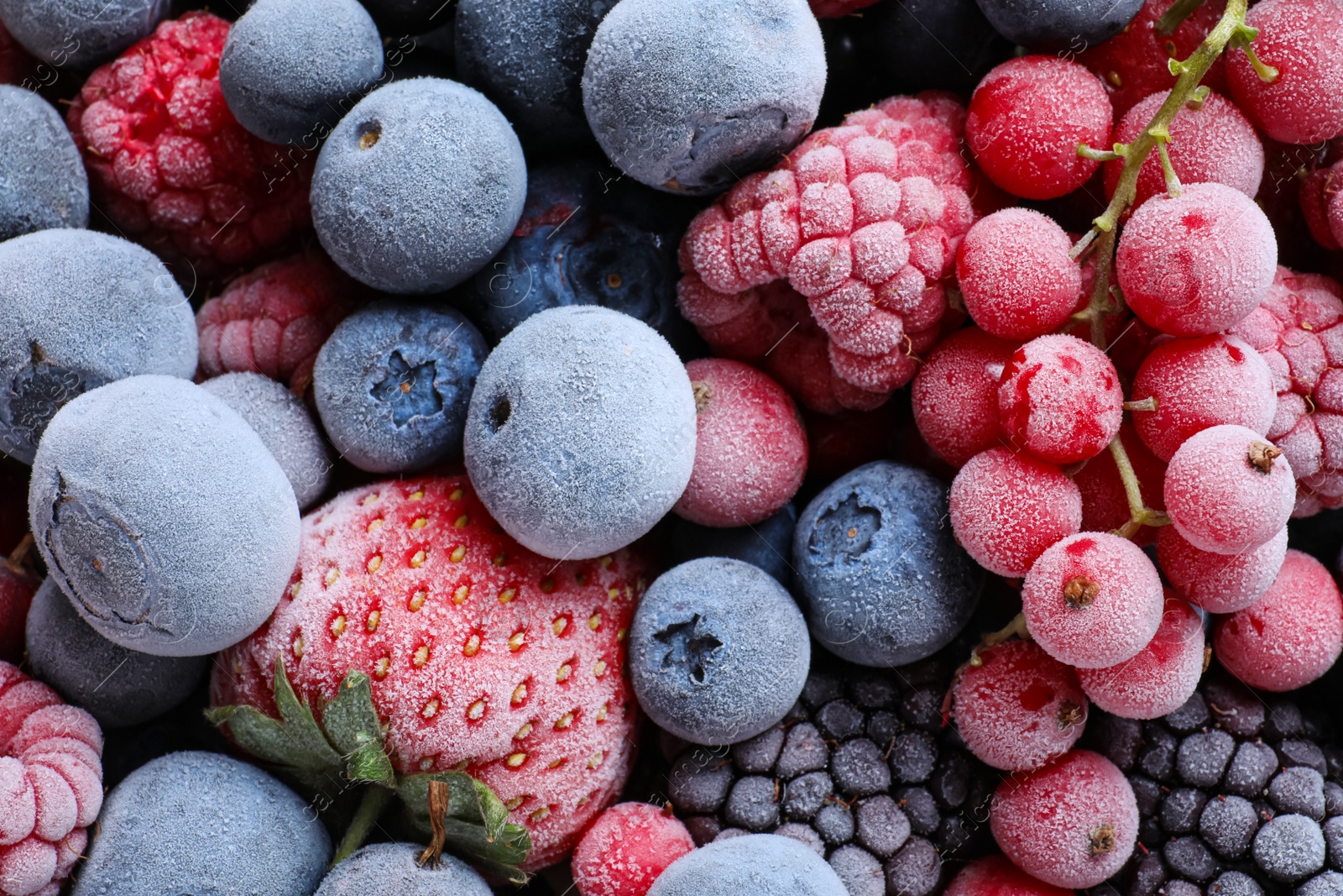 Photo of Mix of different frozen berries as background, top view