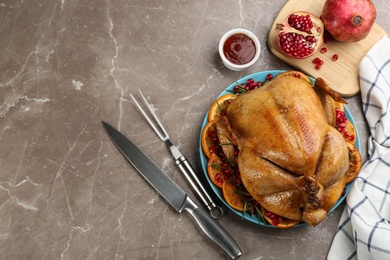 Delicious chicken with oranges and pomegranate on grey table, flat lay. Space for text