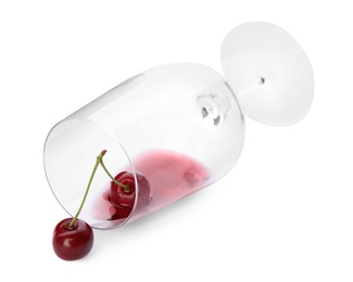 Photo of Overturned glass of delicious cherry wine and ripe juicy berries isolated on white