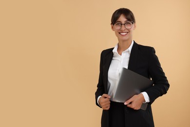 Happy secretary with laptop on beige background. Space for text