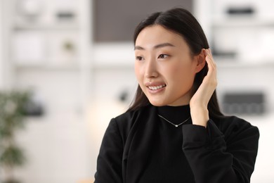 Portrait of smiling confident businesswoman in office