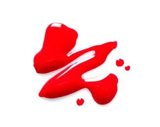 Red nail polish stain on white background, top view