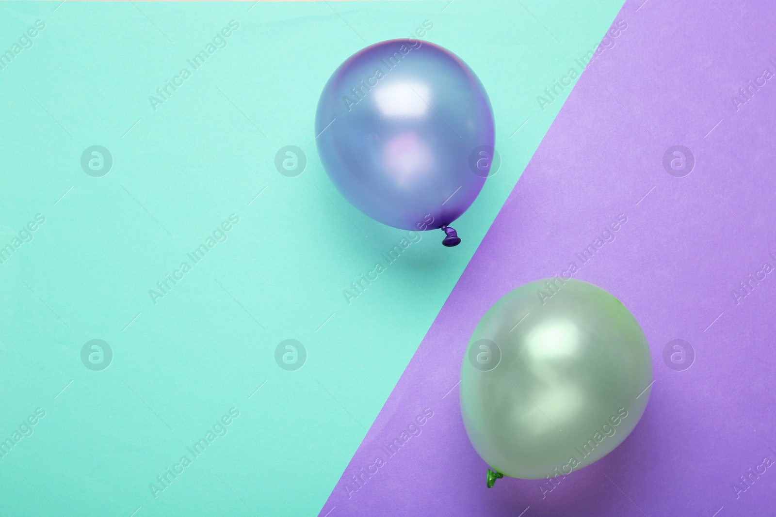 Photo of Flat lay composition with colorful balloons and space for text on color background