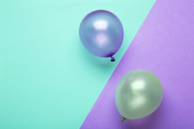 Flat lay composition with colorful balloons and space for text on color background