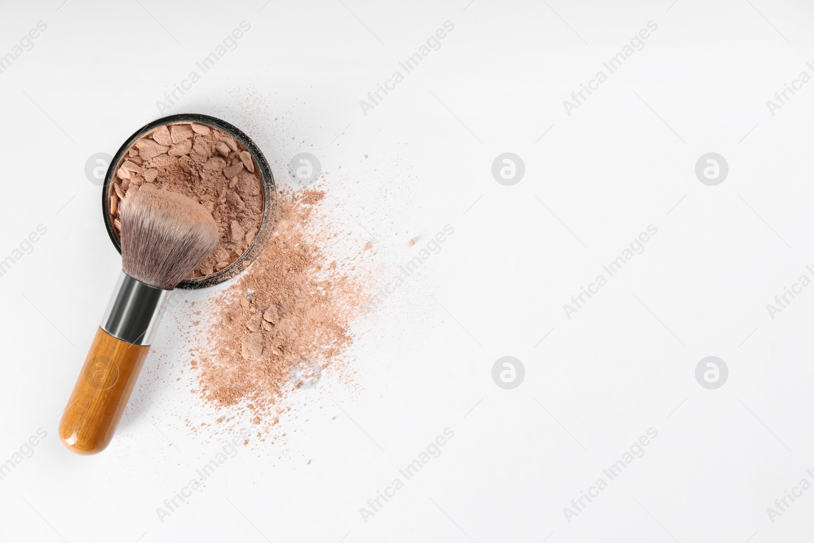 Photo of Makeup brush and face powder on white background, flat lay. Space for text