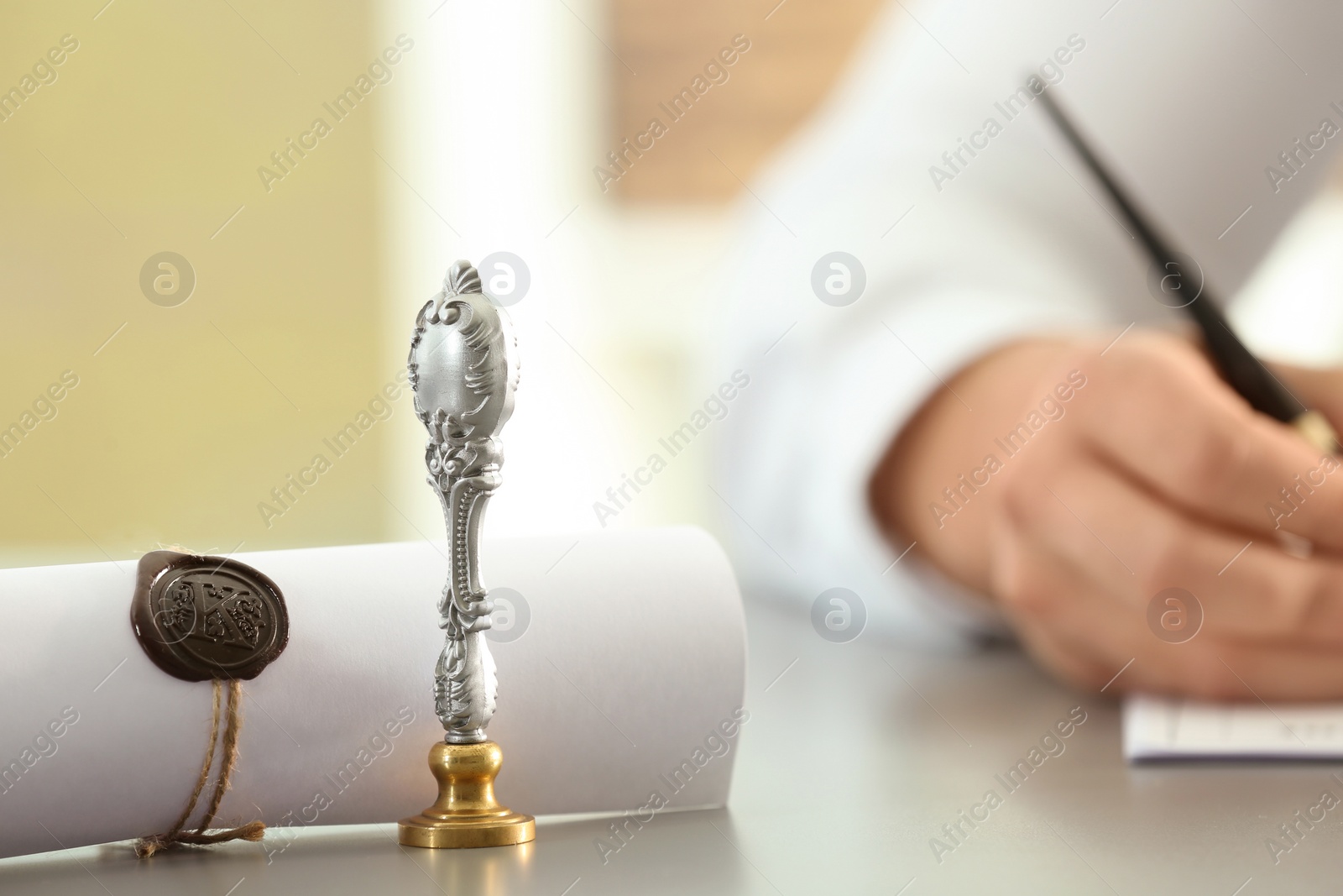 Photo of Vintage stamp, sealed scroll and blurred view of notary on background