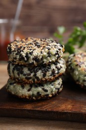 Delicious vegan cutlets with sesame on wooden table, closeup