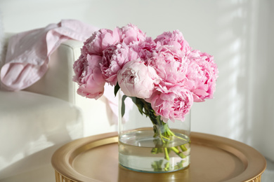 Photo of Bouquet of beautiful peonies on table indoors