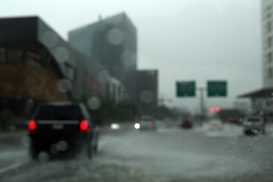 Photo of Road on rainy day, view through car window with water drops