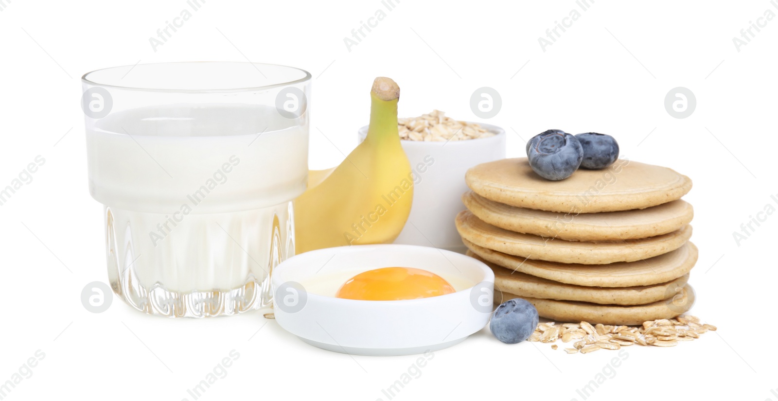 Photo of Tasty oatmeal pancakes and ingredients on white background