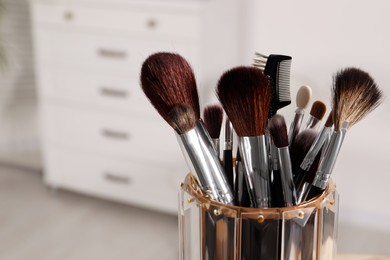Photo of Set of professional brushes indoors, closeup. Space for text