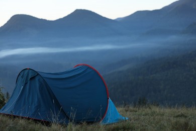 Photo of Camping tent in mountains on early morning