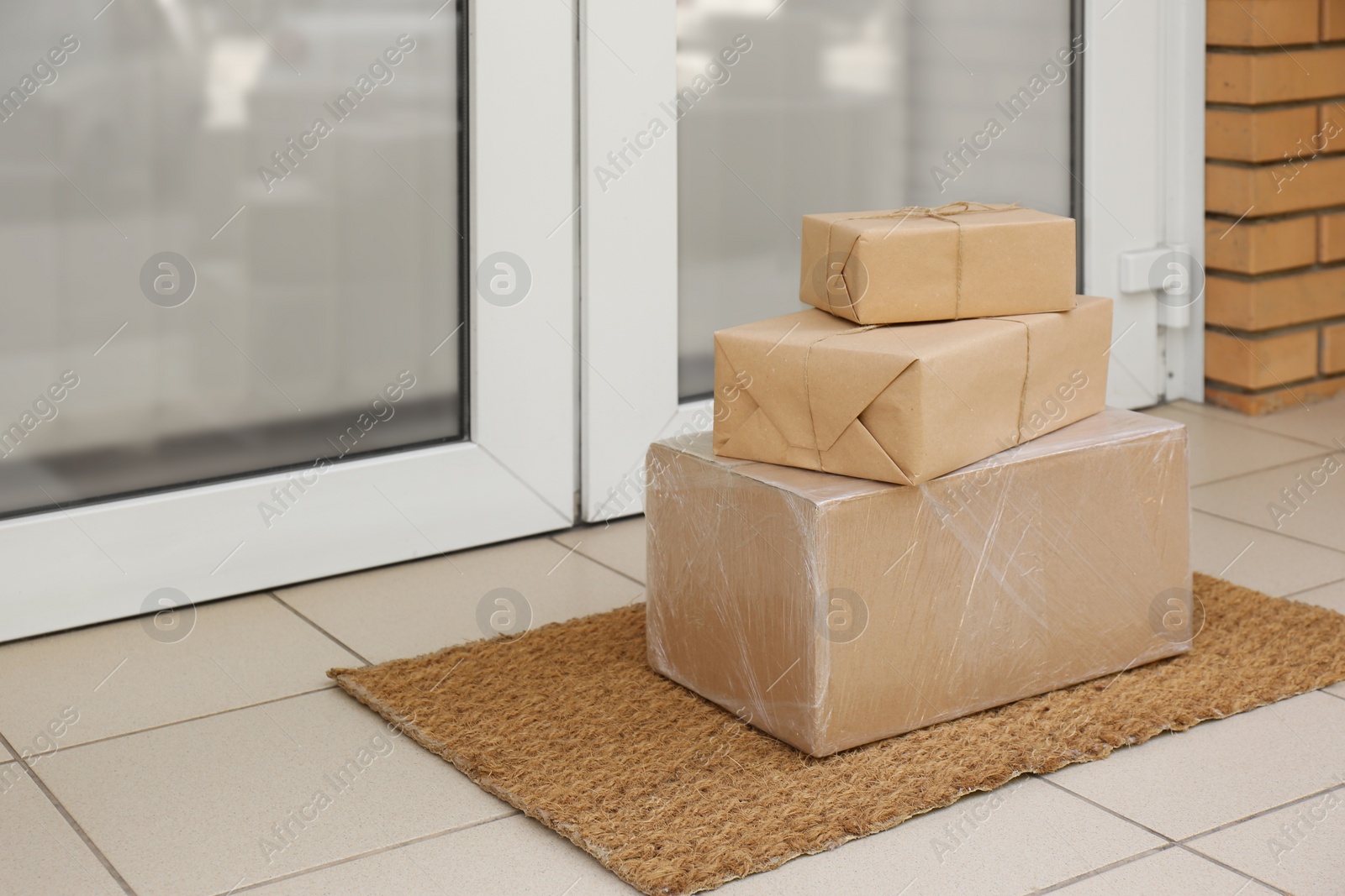 Photo of Delivered parcels on door mat near entrance