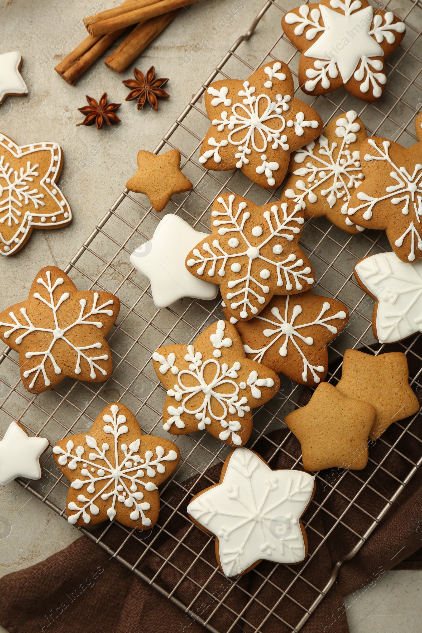 Photo of Tasty Christmas cookies with icing and spices on light table, flat lay