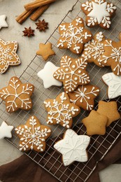 Photo of Tasty Christmas cookies with icing and spices on light table, flat lay