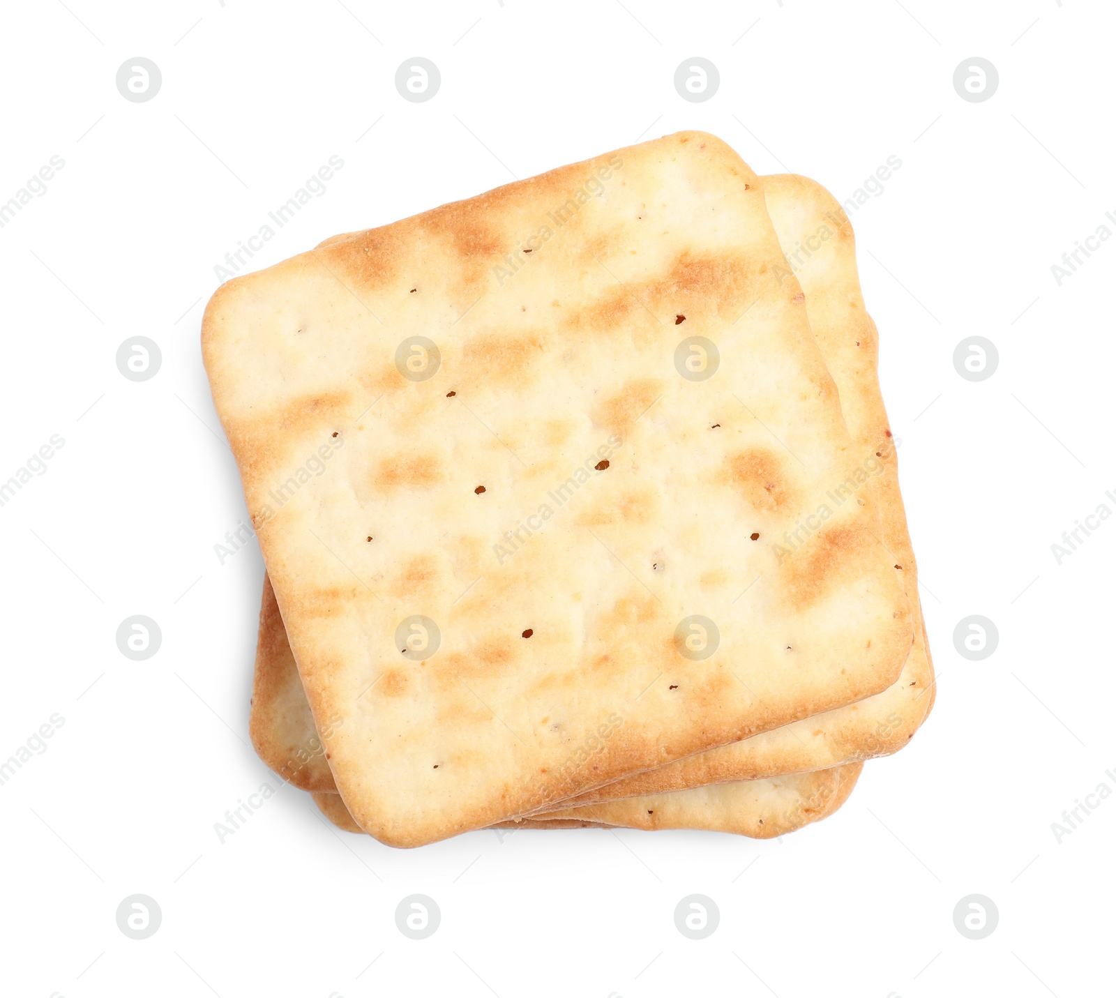 Photo of Tasty crispy square crackers isolated on white, top view