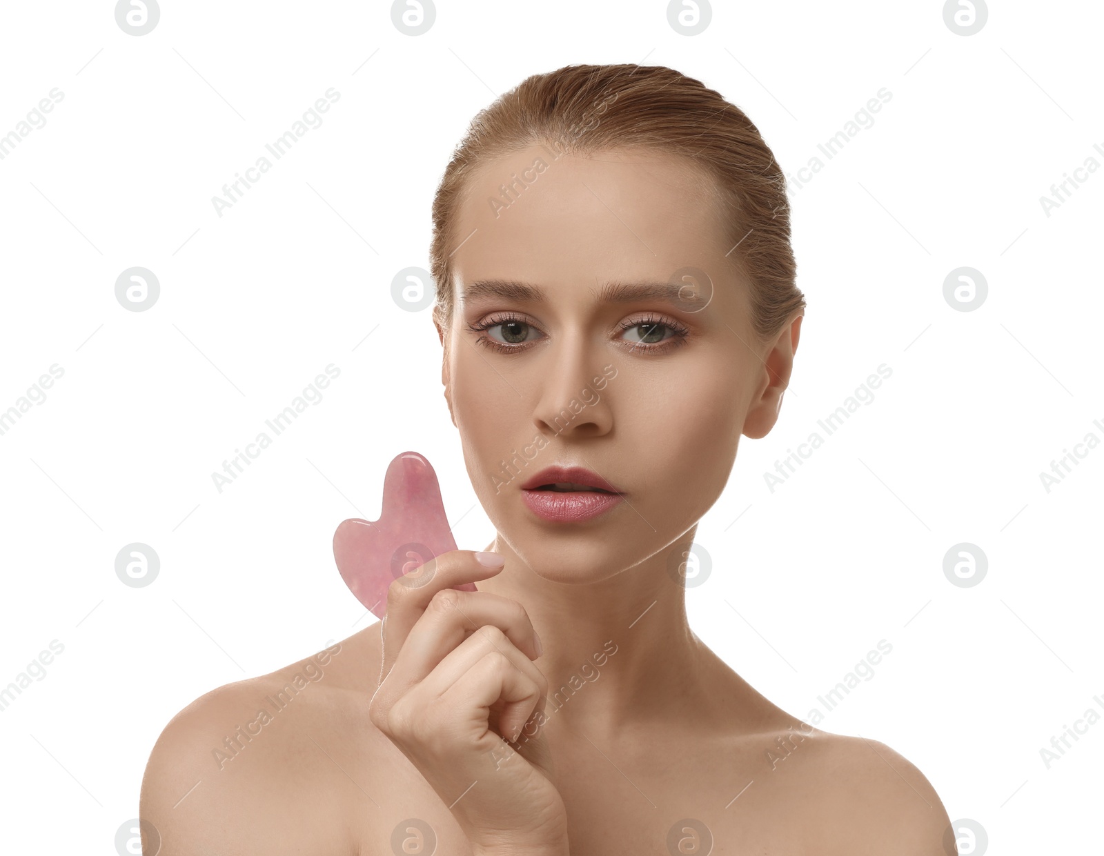 Photo of Beautiful young woman doing facial massage with gua sha tool on white background