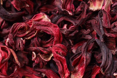 Dry hibiscus tea as background, closeup view