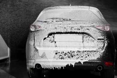 Photo of Automobile covered with foam at car wash