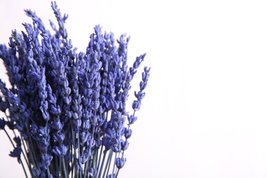 Photo of Bouquet of beautiful preserved lavender flowers on white background, closeup. Space for text