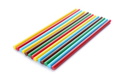 Many colorful glue sticks on white background