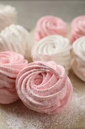 Photo of Delicious pink and white marshmallows on wooden table, closeup