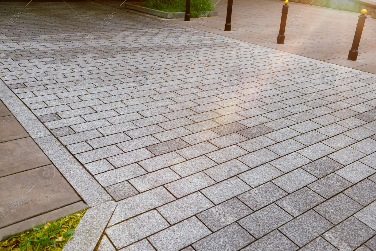 Photo of View on grey stone sidewalk. Footpath covering