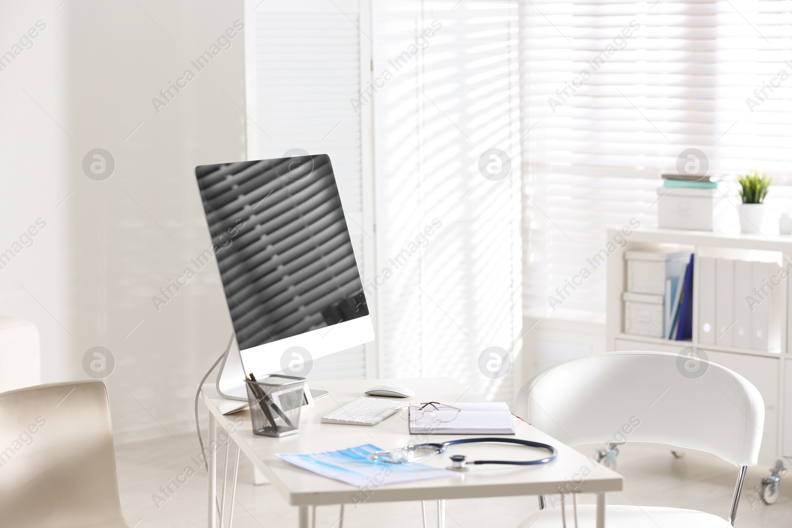 Photo of Doctor's workplace with modern computer in hospital