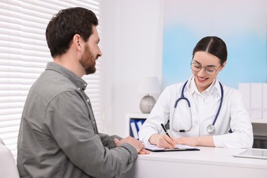 Doctor consulting patient during appointment in clinic