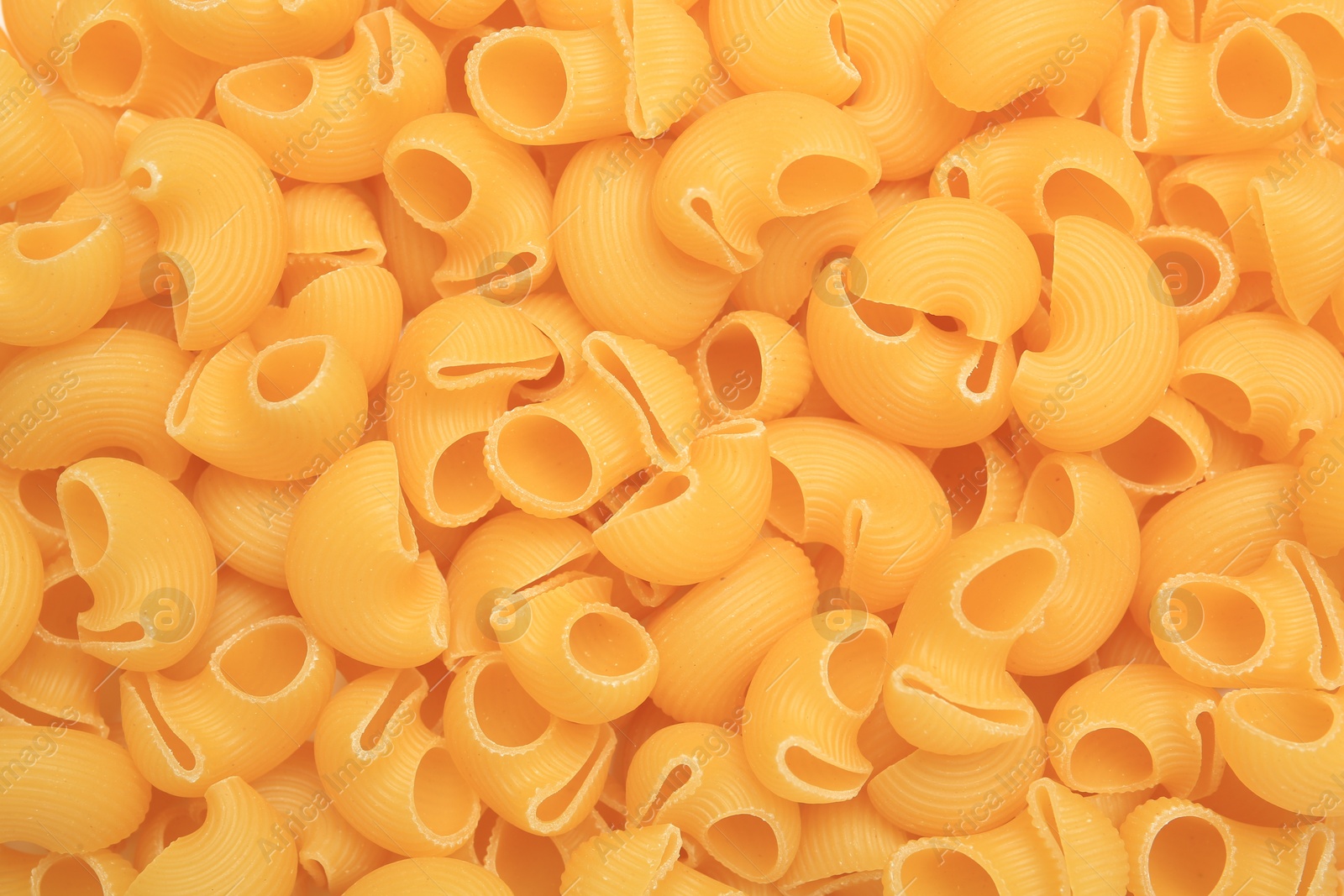 Photo of Raw horns pasta as background, top view