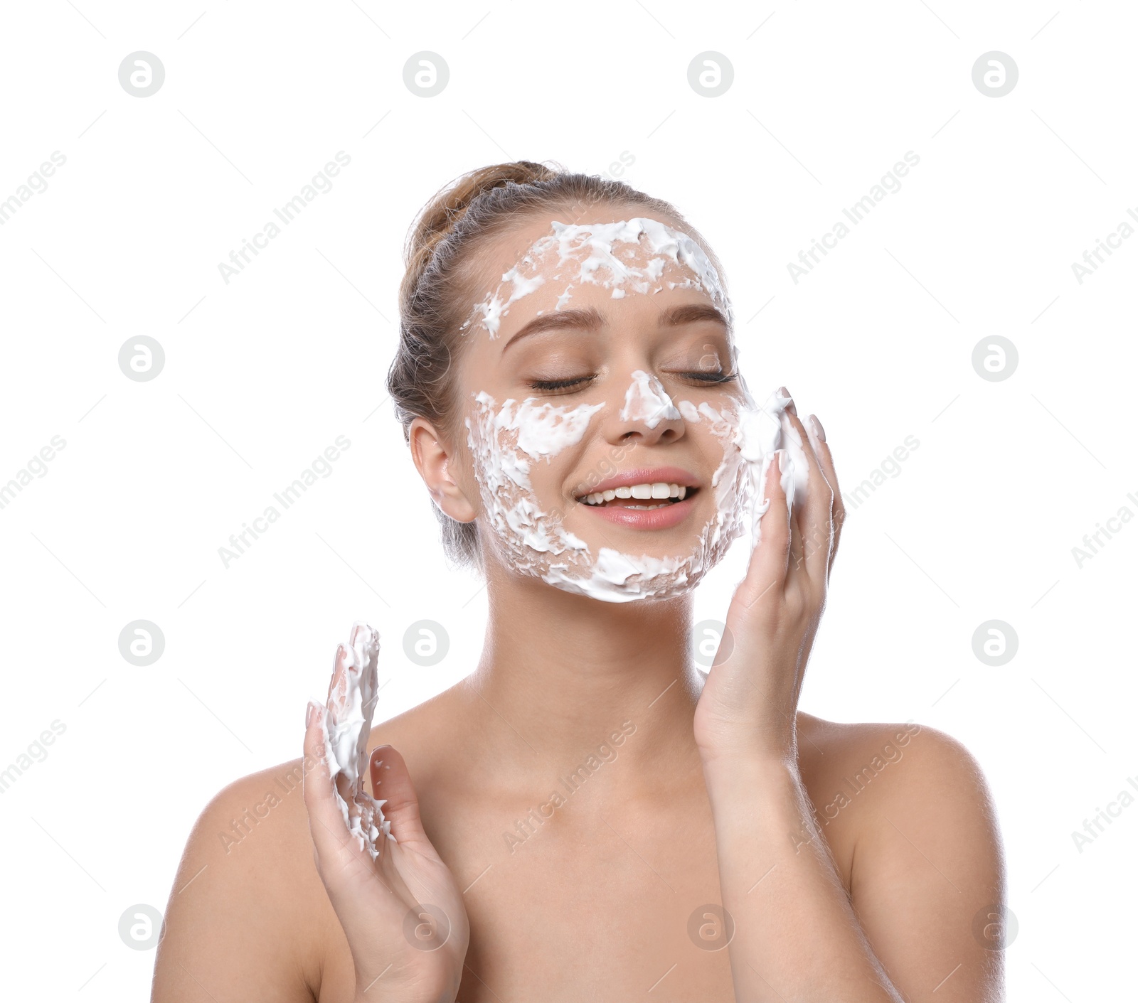 Photo of Young woman washing face with soap on white background