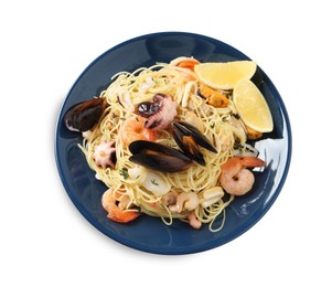 Delicious pasta with sea food in plate isolated on white, top view