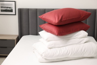 Photo of Soft pillows and duvet on bed at home. Space for text