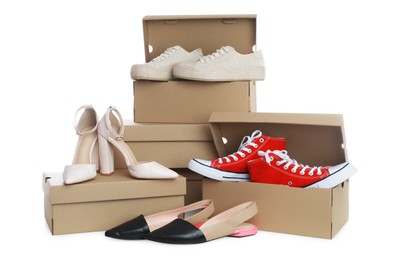 Photo of Different stylish shoes and cardboard boxes on white background