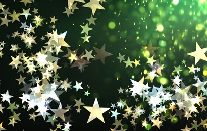 Many beautiful shimmering stars and blurred lights on green background. Bokeh effect