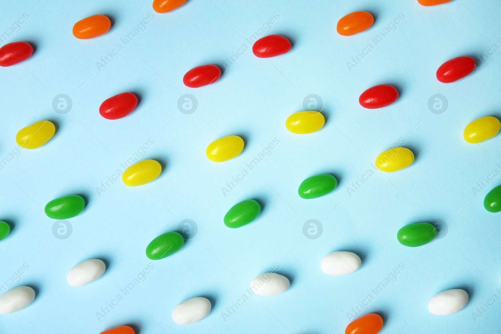 Photo of Flat lay composition with jelly beans on color background