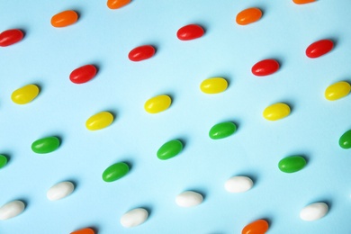 Photo of Flat lay composition with jelly beans on color background