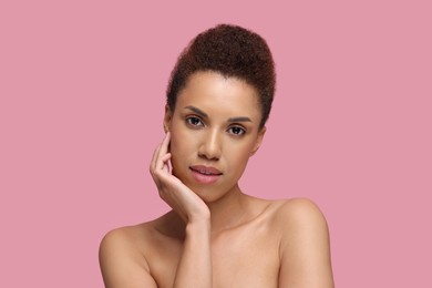 Photo of Portrait of beautiful young woman with glamorous makeup on pink background