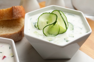 Photo of Delicious cold summer soup in bowl on table, closeup