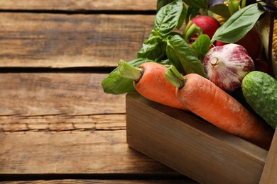 Many different vegetables on wooden table, space for text