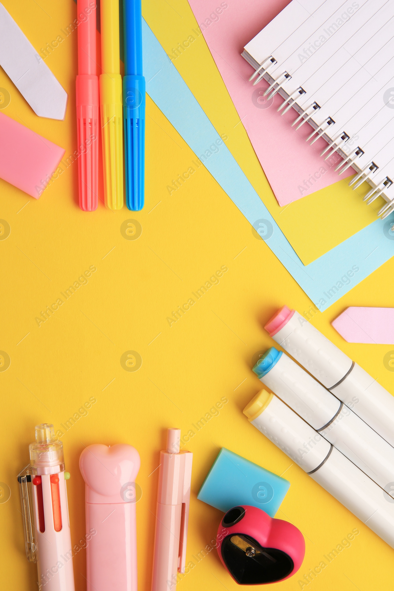 Photo of Different school stationery on yellow background, flat lay with space for text. Back to school
