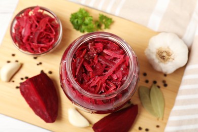 Jar with delicious pickled beetroot and spices on table, top view