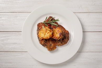 Photo of Plate with tasty grilled meat and potatoes on table, top view